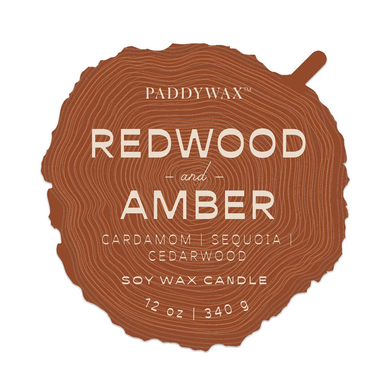 A tree cross-section label for the Paddywax Redwood & Amber - Grain 12 oz Candle, featuring cardamom, sequoia, and cedarwood notes from their woodgrain collection (340g).