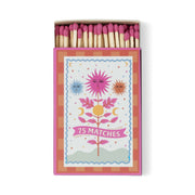 The A Dopo "Sun" - 75ct Boxed Matches feature a pink and orange box with floral, sun, and moon designs, holding pink-tipped safety matches—perfect for lighting your favorite A Dopo candle.