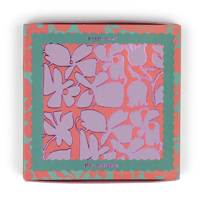 The Abstract Floral - Teal Matches matchbox features a purple and pink floral pattern with teal and coral borders, holds 100 jumbo matches—perfect as a candle accessory.