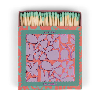An open matchbox of jumbo matches with green tips and an abstract floral design in teal, labeled “Abstract Floral - Teal Matches”—a stylish candle accessory.
