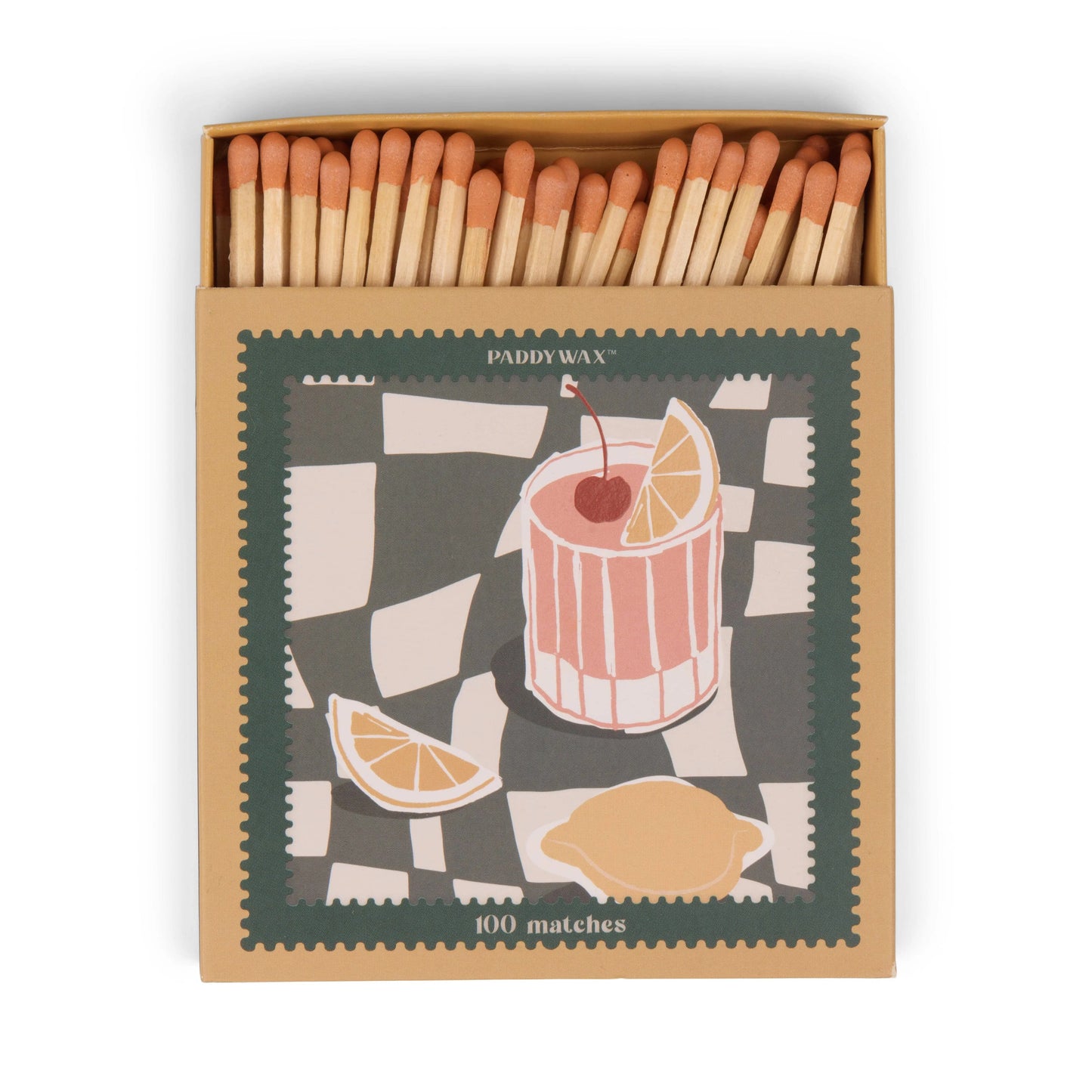 An open matchbox of jumbo matches labeled Cocktail - Orange Matches, this candle accessory features a decorative cover with a drink, cherry, and lemon slices on a checkered background.