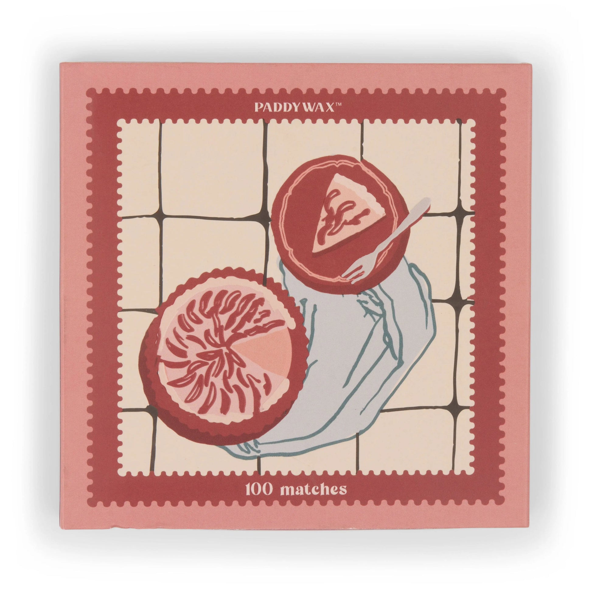 The Picnic & Pie - Peach Matches is a pink and red matchbox featuring 100 matches and an illustration of a hand holding a grapefruit half on a tiled background.