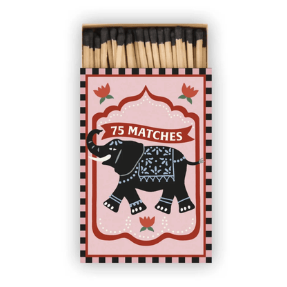 A Dopo "Elephant" - 75ct Boxed Matches feature a pink label with a black elephant, red flowers, white "75 MATCHES" text, and a black & white striped border that adds Mediterranean travel charm.