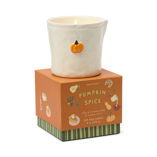 Pumpkin spice candle with decorative packaging on a white background