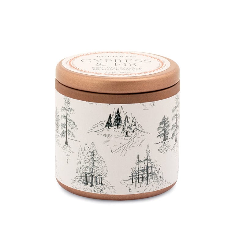 The Cypress & Fir Copper Tin Candle features a round tin with a copper lid and a white label adorned with black line illustrations of trees and mountains, creating a nature-inspired look.