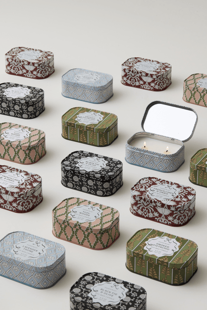 Decorative tin candles with various patterns on a white background