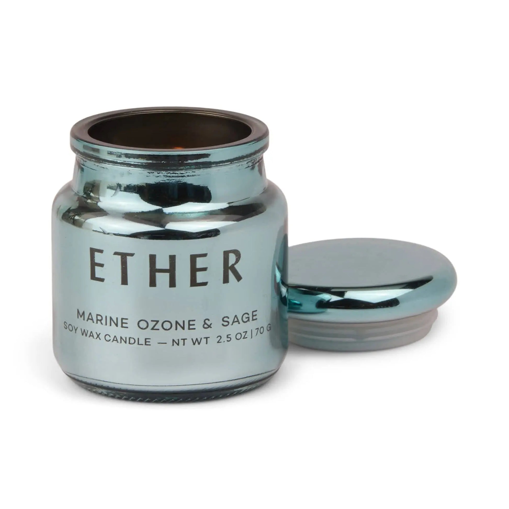 A metallic blue glass jar labeled Sea Salt & Sage - Chroma Candle 2.5 oz, its lid off and set beside it—part of the vibrant Chroma collection.