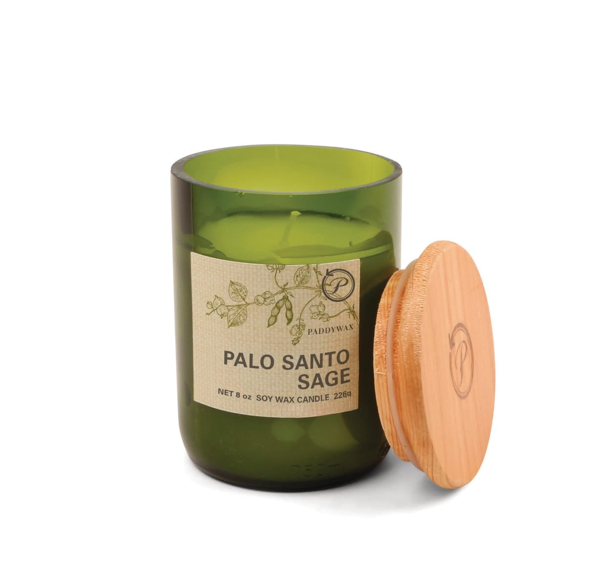 A green glass Palo Santo Sage - Eco 8 oz Candle with a wooden lid leans against it. The label reads Soy Wax Candle, showcases botanical illustrations, and emphasizes its sustainable design.