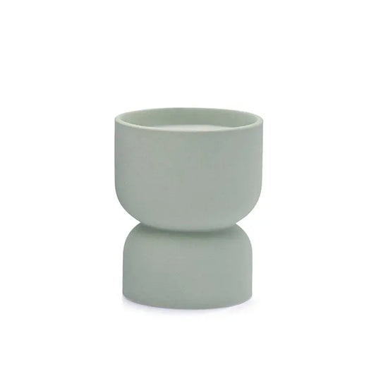 The Ocean Rose & Bay - Form 6 oz Candle features a minimalist, light gray-green ceramic cup with a rounded top and subtly wider base, ideal for home decor. Shown against a white background.