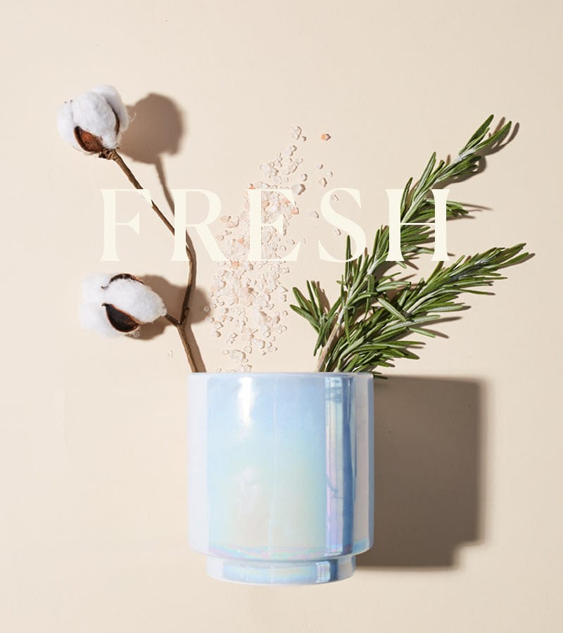 A shiny light-blue cup holds rosemary sprigs, cotton stems, and scattered sea salt on a beige background. The word FRESH is overlaid in large white letters.
