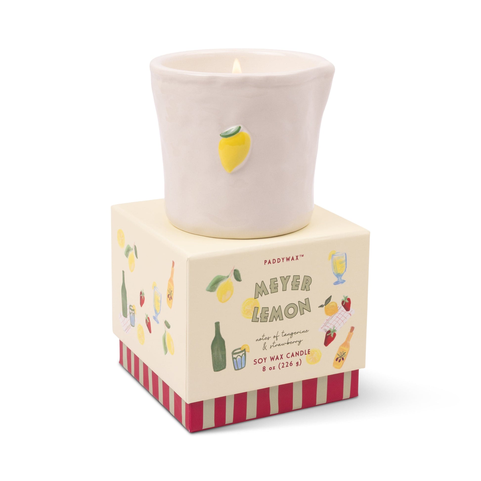 The Meyer Lemon - Bistro 8 oz Candle features a white ceramic holder with a small lemon accent, presented in a vibrant box with lemon and drink designs—ideal for aromatic candle collections or as a thoughtful gift.
