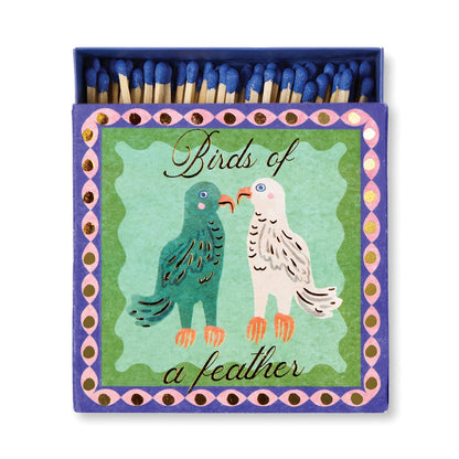 Birds of a Feather - Square Boxed Matches: purple matchbox with blue-tipped matches, two birds illustration, and Birds of a Feather text on green with a pink and gold border—an ideal sentimental gift.