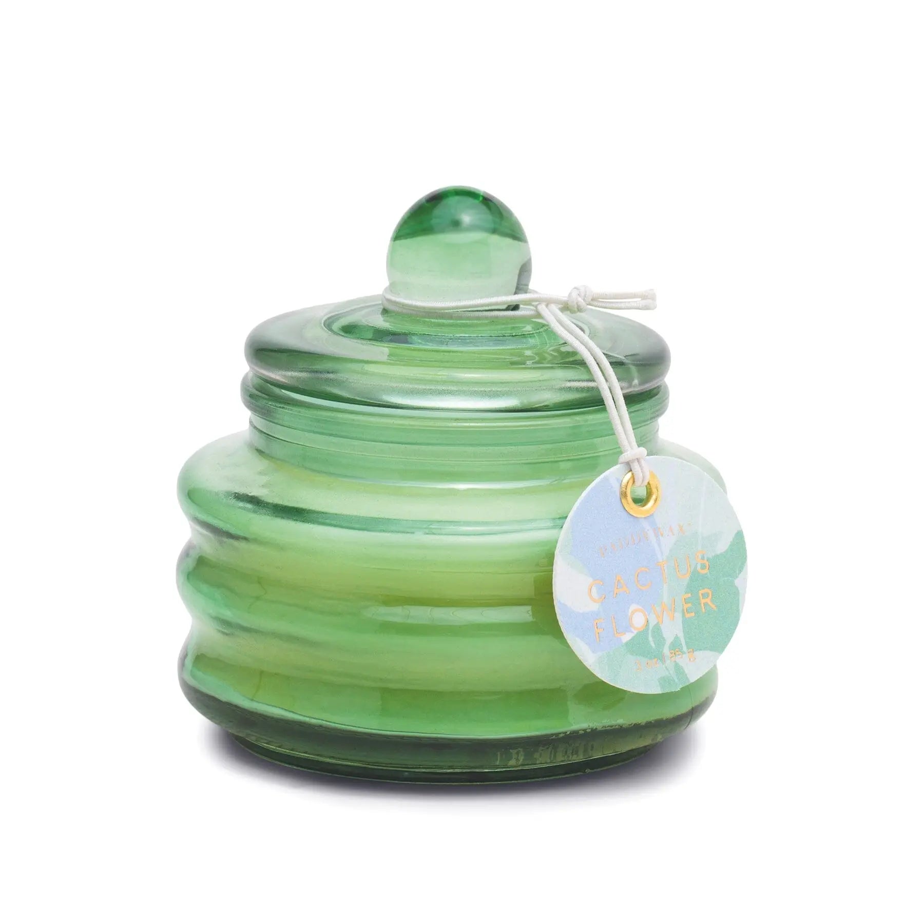 The Cactus Flower - Beam 3 oz Candle is a green glass jar with a rounded lid and knob, featuring a white string tag—an ideal gift candle offering a fresh springtime scent.