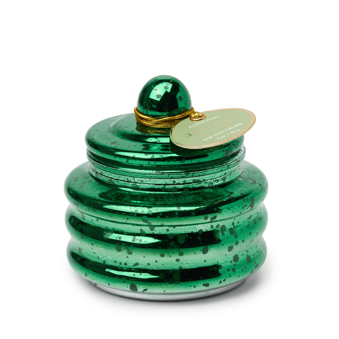 The Balsam & Fir - Beam 3 oz Candle is a shiny green ribbed glass jar with black speckles, a round lid, and gold string with an oval tag—making it a perfect holiday gift or charming Christmas party favor.