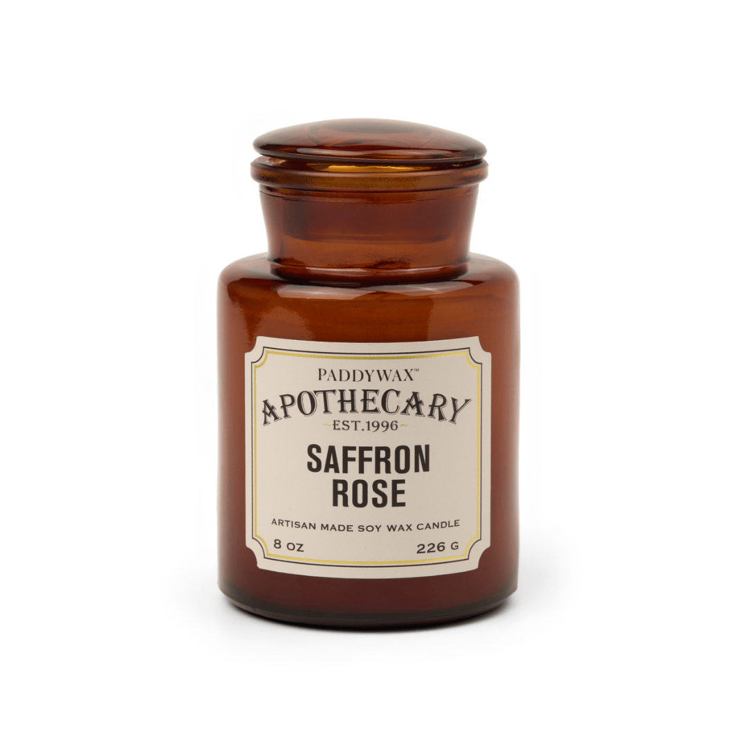Brown candle jar labeled 'Saffron Rose' by Paddywax on a white background