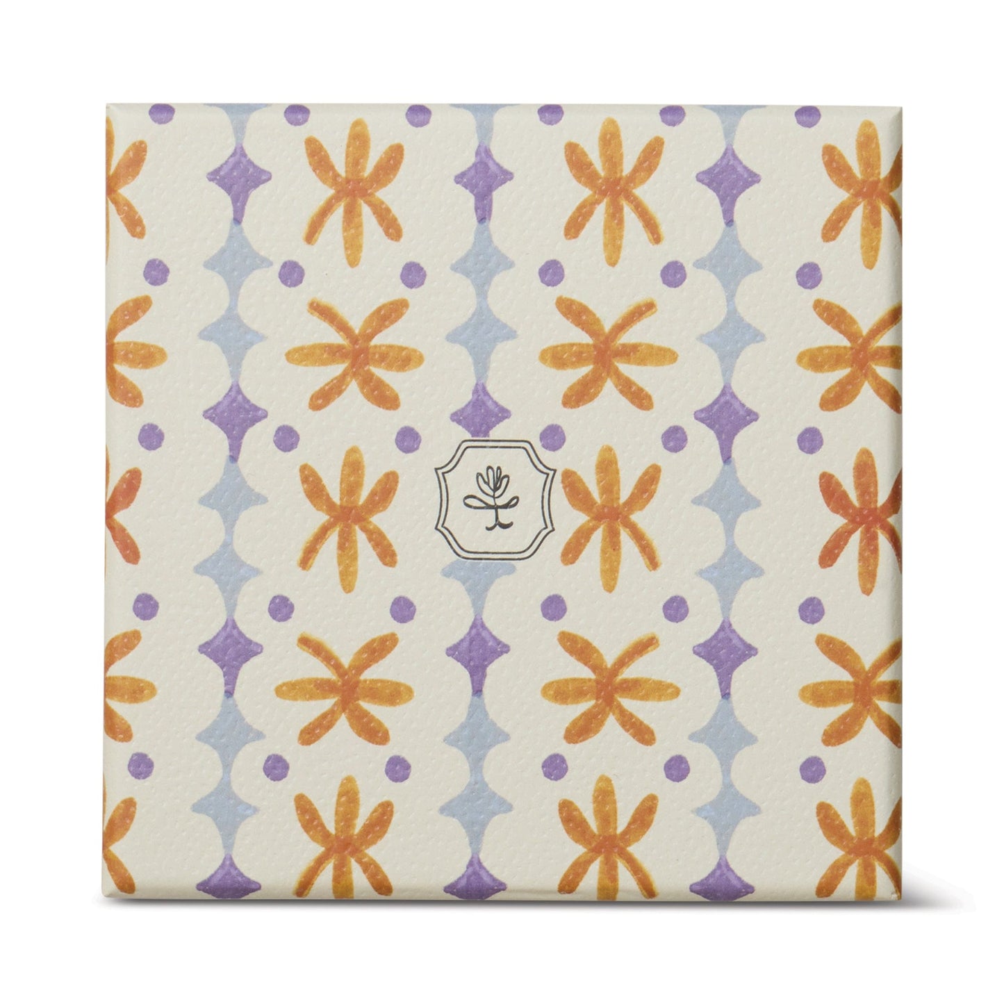 The Garden & Grove - Tulip 5.5 oz Candle comes in a square, cream-colored rustic vessel with orange flowers, purple diamonds, and a central emblem of a simple line flower—ideal for garden-inspired home decor.