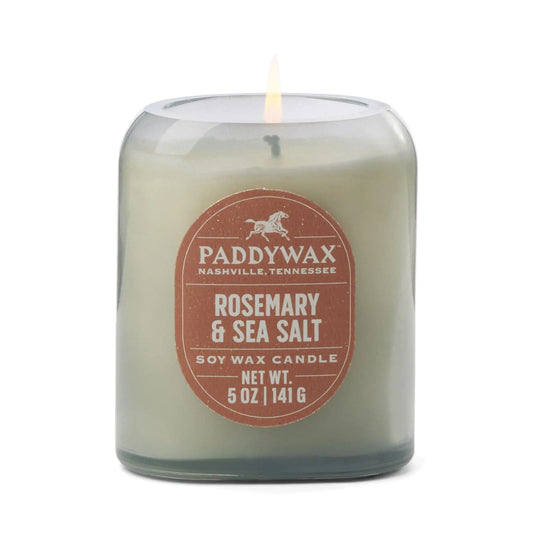 The Rosemary & Sea Salt - Vista 5 oz Candle adds a modern touch and luxe scent to your home, featuring a glass jar with a brown label and net weight of 5 oz (141 g).