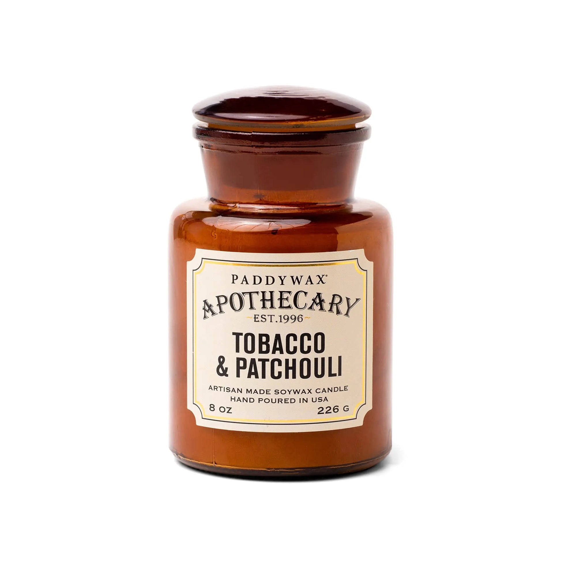The Tobacco + Patchouli - Apothecary 8 oz Candle is a brown glass jar soy wax candle featuring a vintage-inspired scent, adding a touch of luxury fragrance to your home.