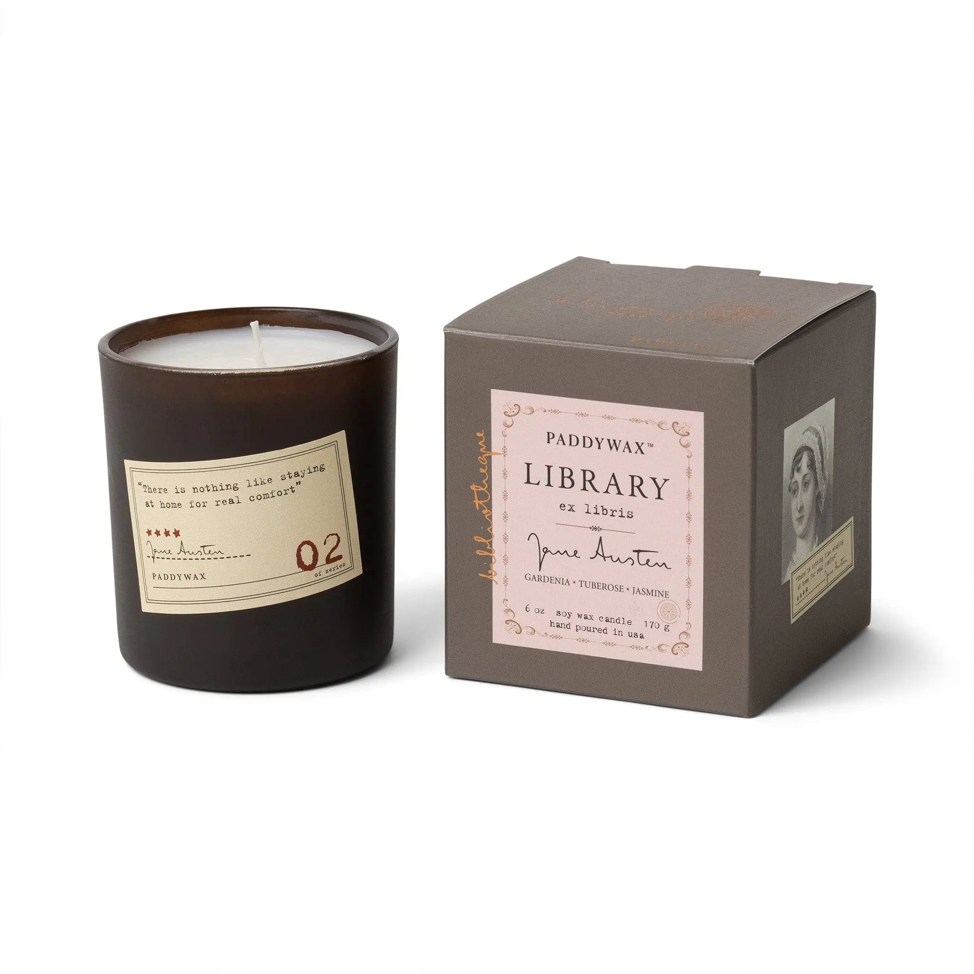 The Jane Austen - Library Candle 6 oz in a dark glass jar sits beside its brown Paddywax Library Collection box, featuring a portrait and quote—an ideal literary gift for fans of candlelight and classic novels.
