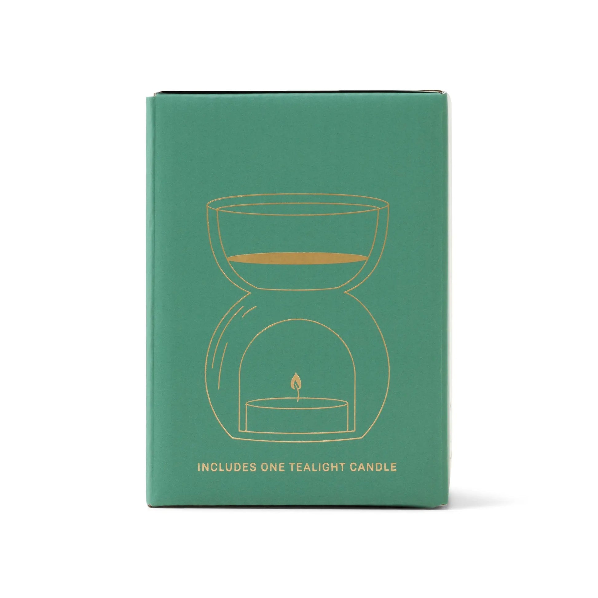 The Sage Green Glass - Essential Oil Burner & Tea Light Candle features a gold line art of an oil burner above a tealight on the box, plus text that says “Includes one tealight candle.”.