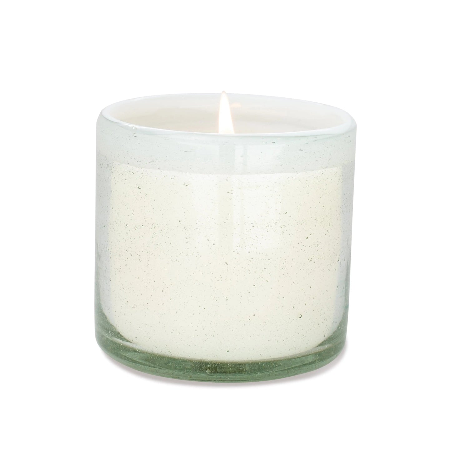 The Amber + Coconut - La Playa 9 oz Candle glows in a clear, hand-blown bubble glass container against a plain white background.