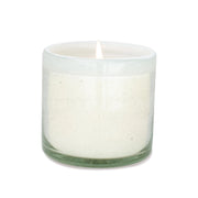 The Amber + Coconut - La Playa 9 oz Candle glows in a clear, hand-blown bubble glass container against a plain white background.