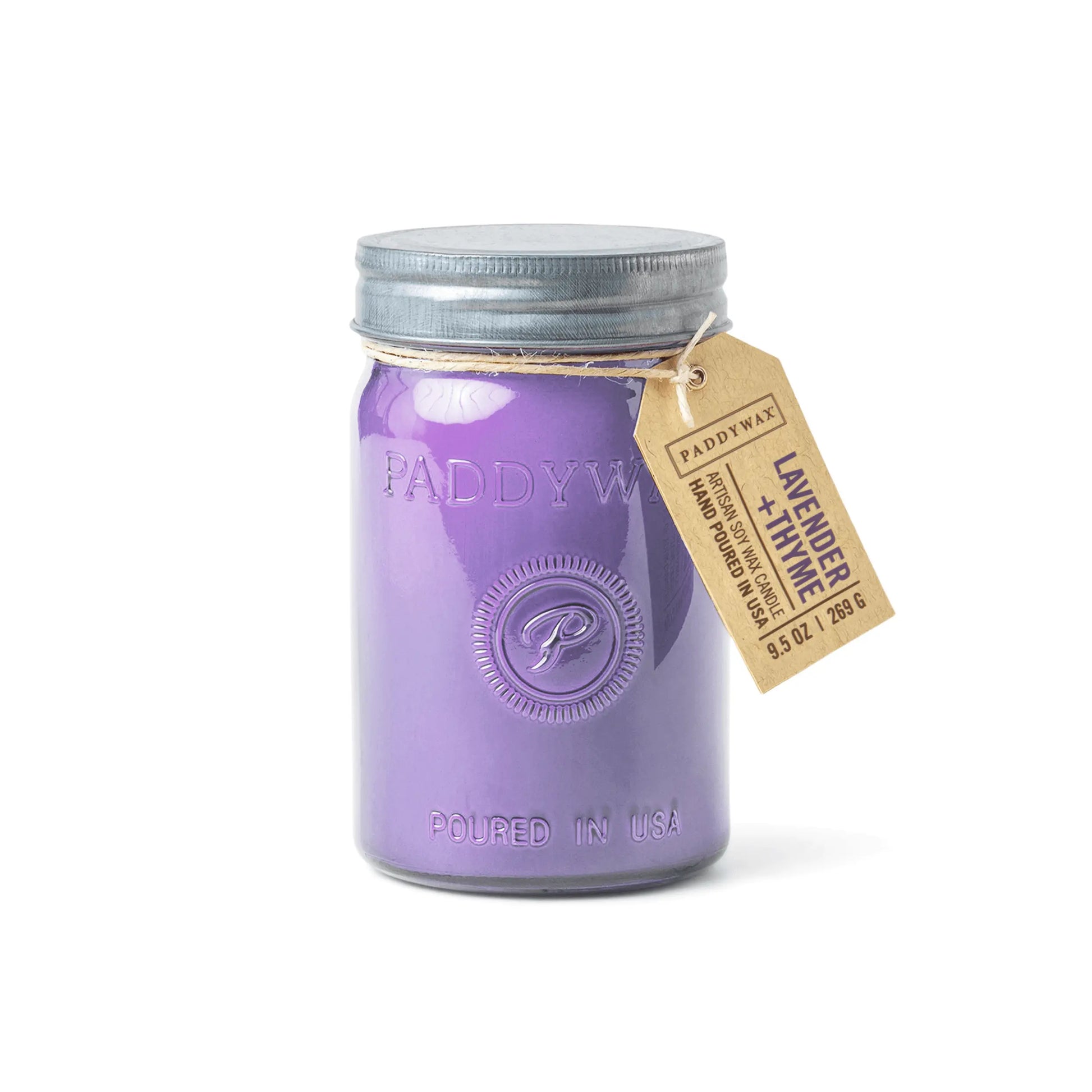 The Lavender + Thyme - Relish 9.5 oz Candle is a purple scented candle in a glass storage jar with a metal lid and tag labeled Lavender + Thyme.